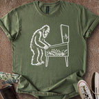 Printify T-Shirt Military Green / S 0182_bigfoot playing pinball T-Shirt